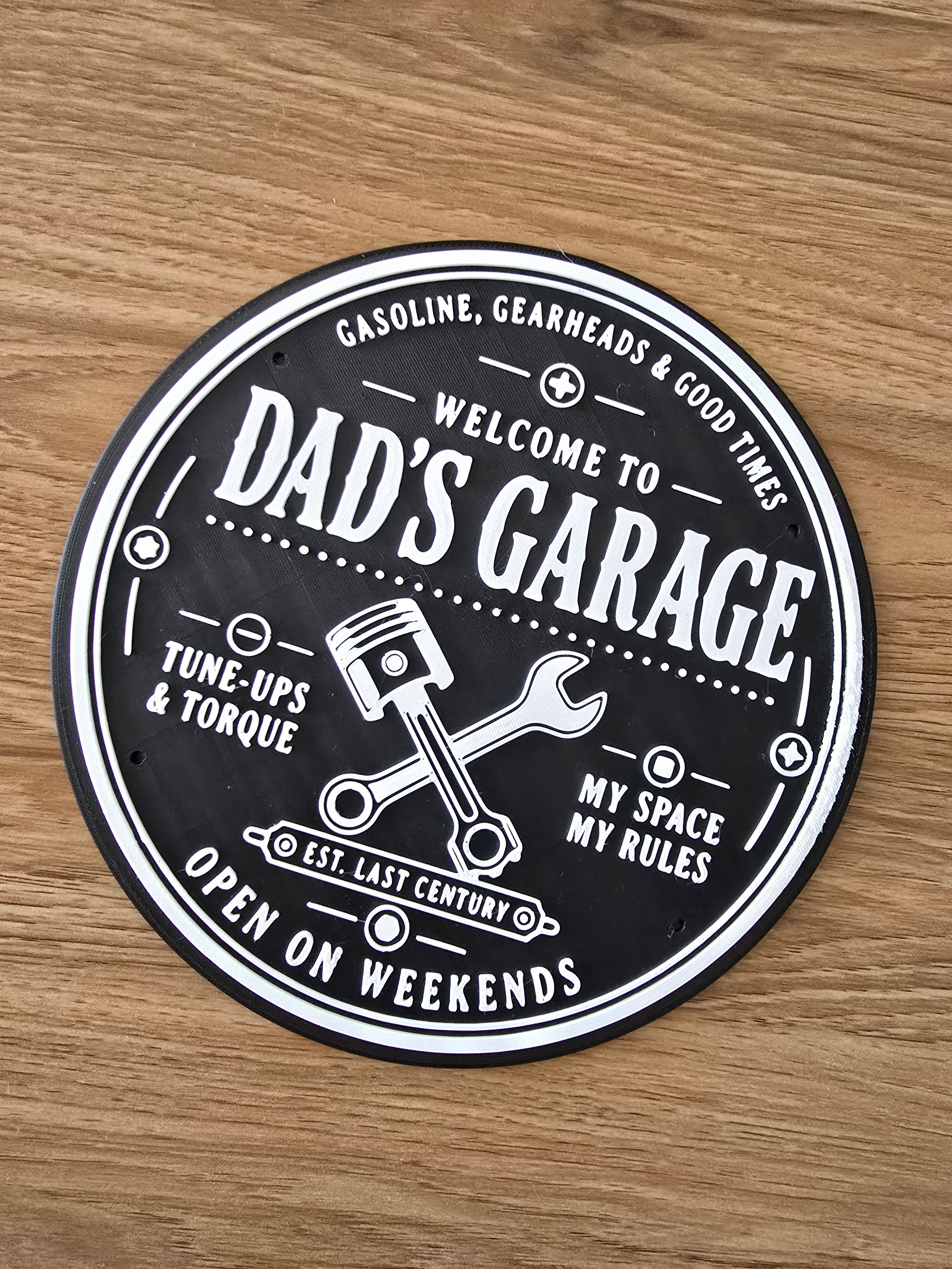 3D printed Dad's Garage circular wall plaque in black and white
